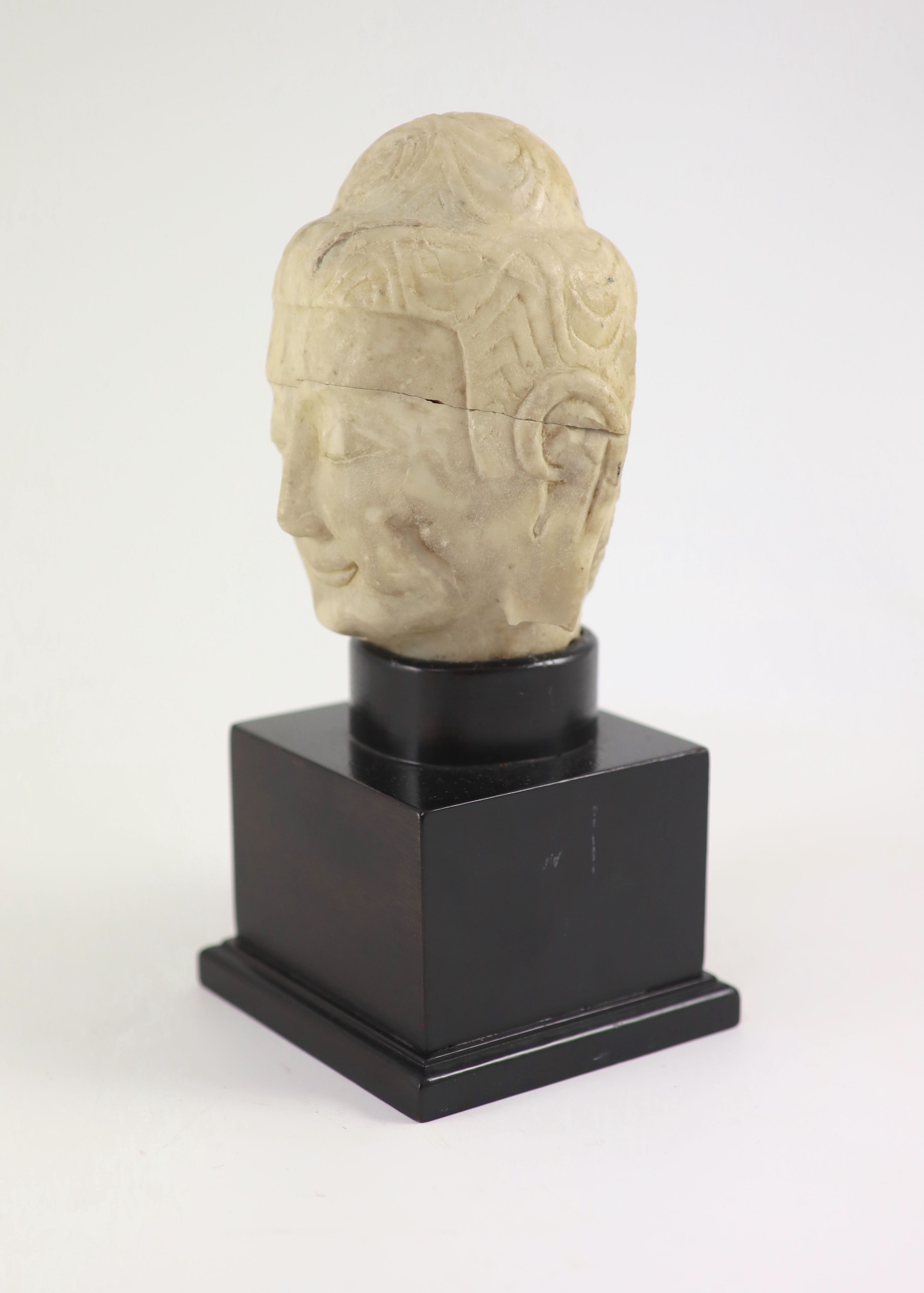 A Chinese carved white marble head of Buddha, Tang dynasty (618-907 AD), 16 cm high excluding later stand, old repairs